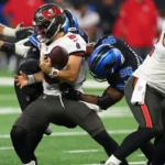 Detroit's defense swarms Tampa Bay quarterback Baker Mayfield. Photo: