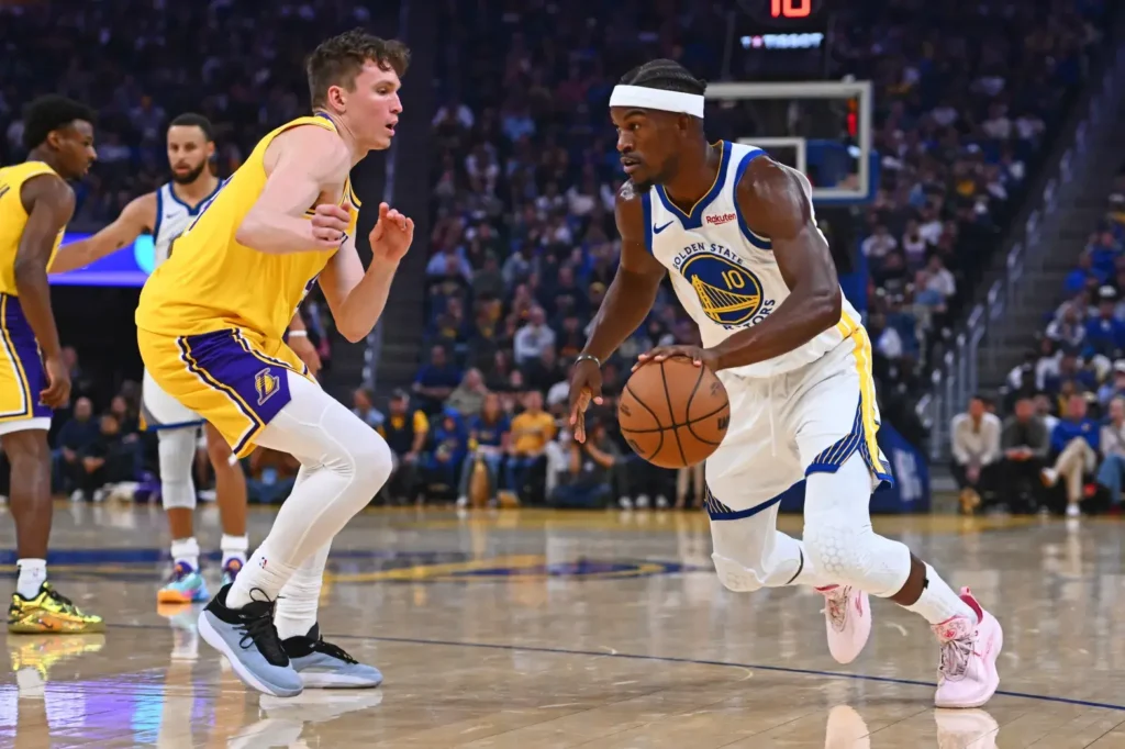 Golden State Warriors’ Jimmy Butler III (10) drives past Los Angeles Lakers’ Dalton Knecht (4)
