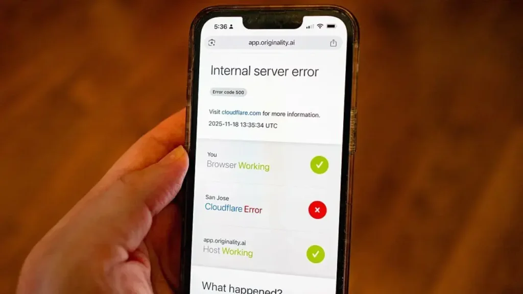 Person’s handing hold an iPhone displaying a Cloudflare Error while attempting to access