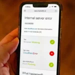 Person’s handing hold an iPhone displaying a Cloudflare Error while attempting to access